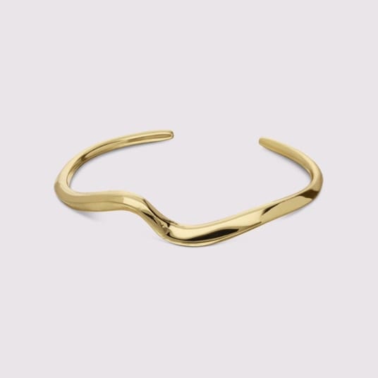Plain polished 22K gold bangle on a white background
