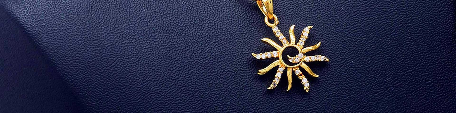 Gold sun pendant set with small white stones on navy leather