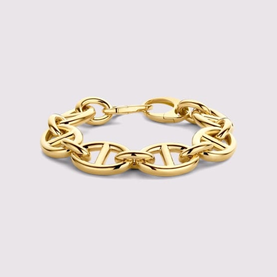 Gold curb-link bracelet with a box clasp on a white background